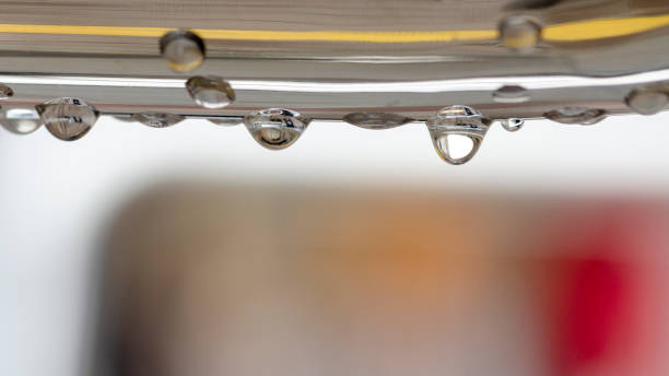 image of droplets falling from a rail